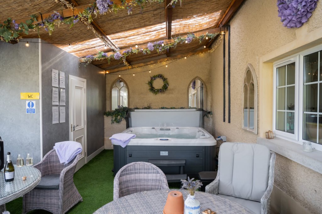 Covered hot tub and outdoor seating at Lavender Manor