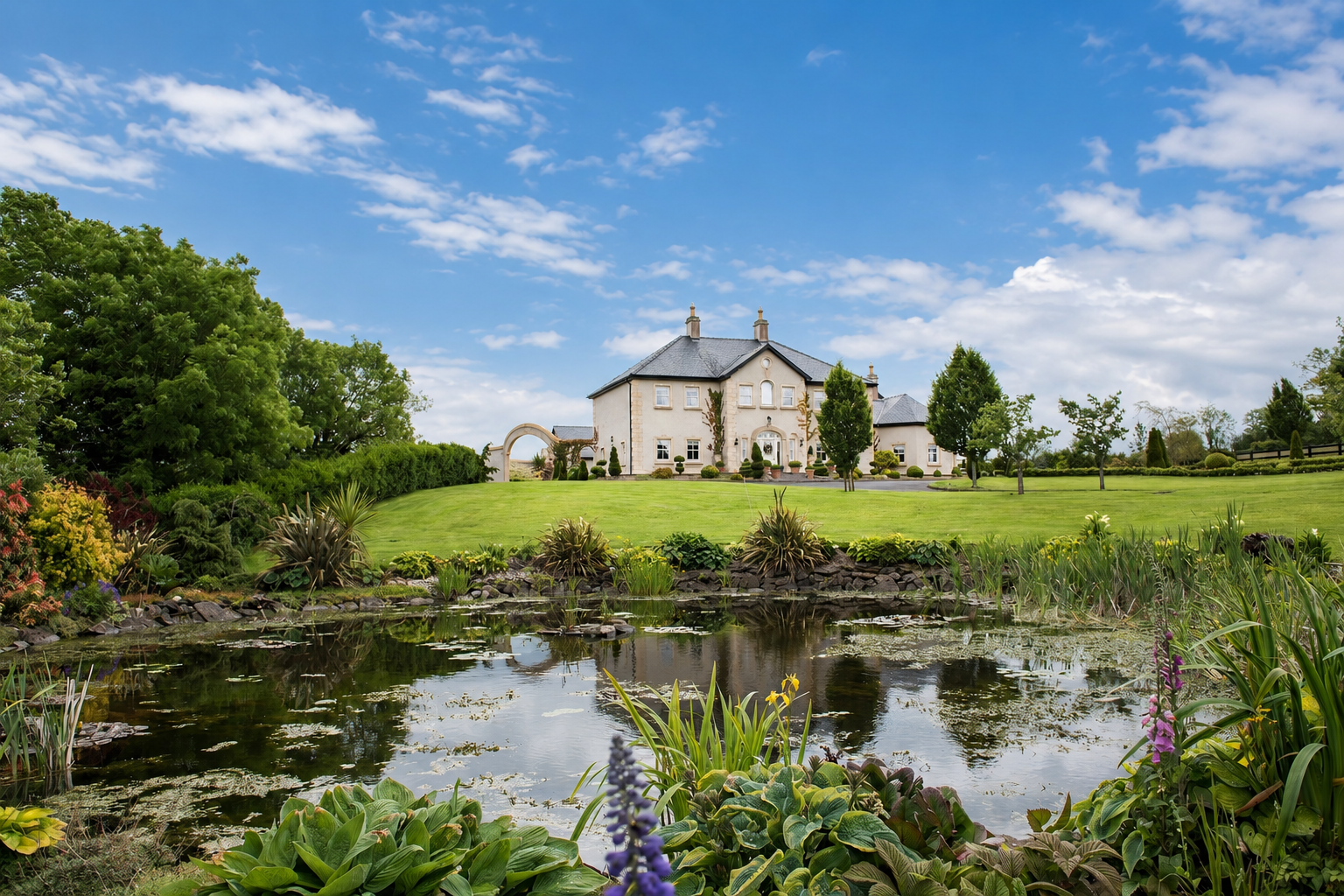 Lavender Manor and landscaped grounds reflected in the pond